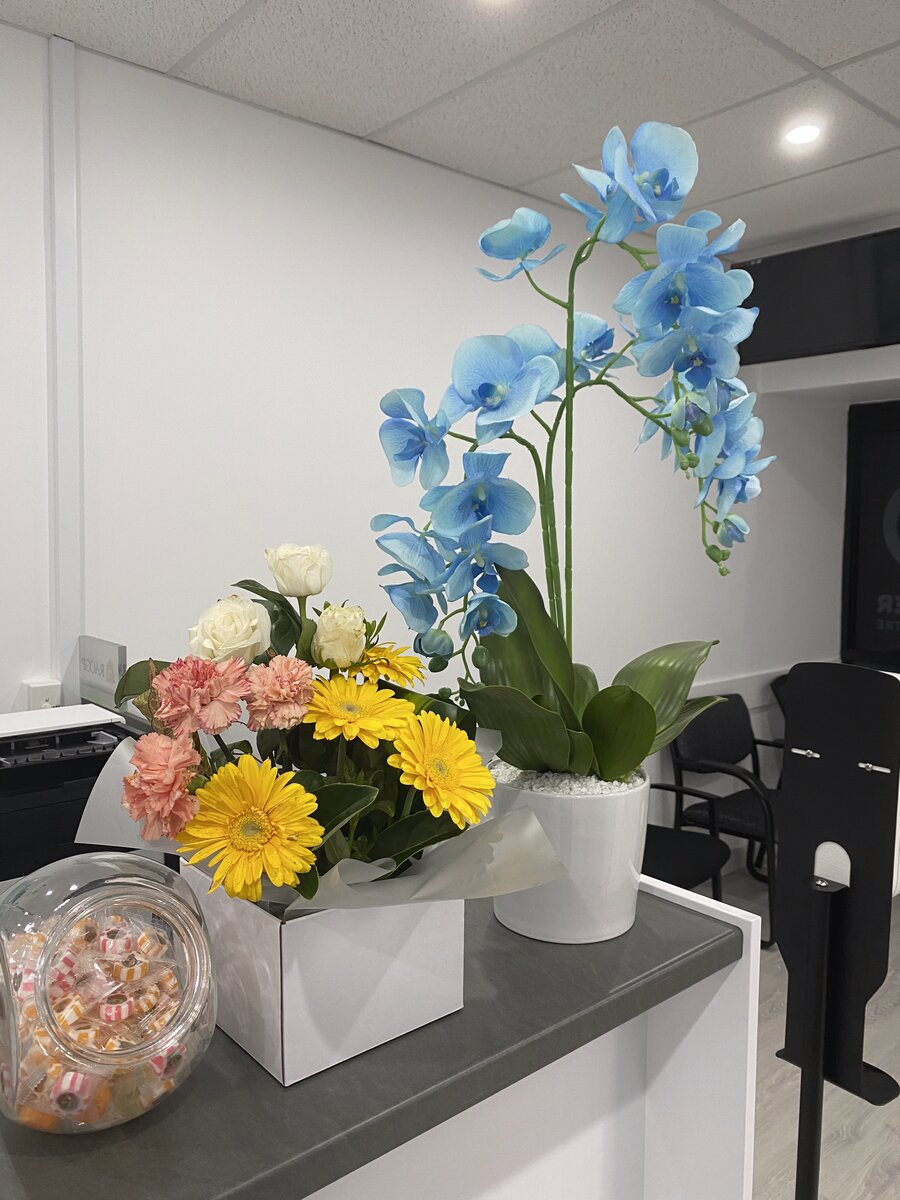 Blue orchids and flowers at the front desk