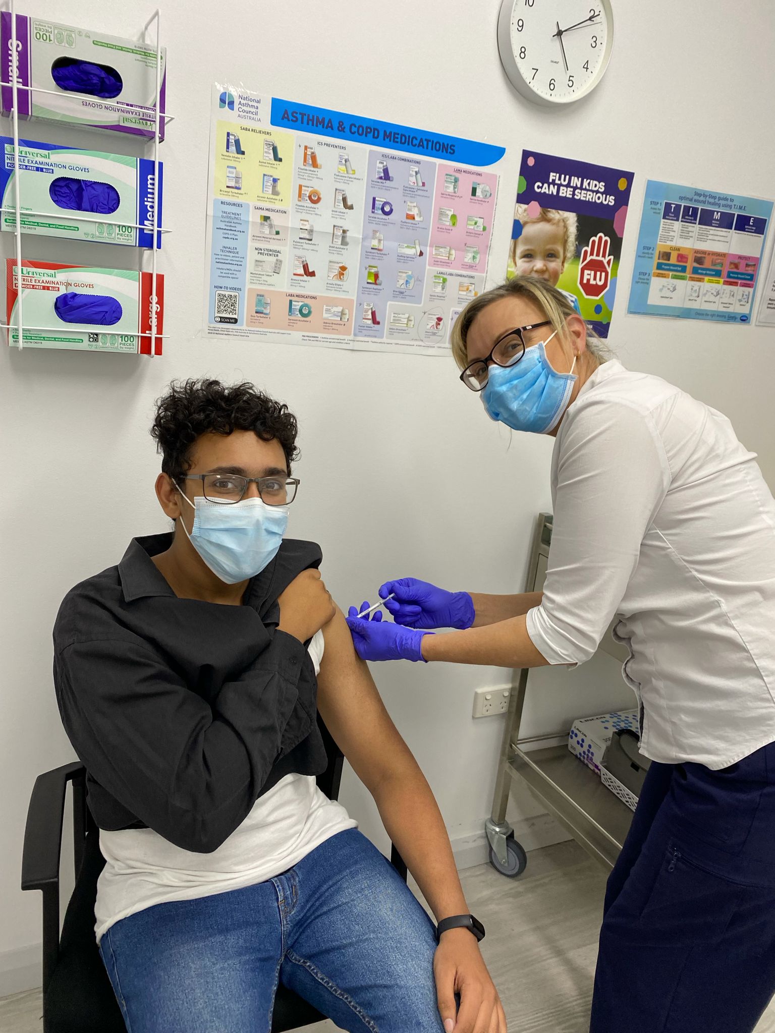Nurse administering an immunisation to a young patient