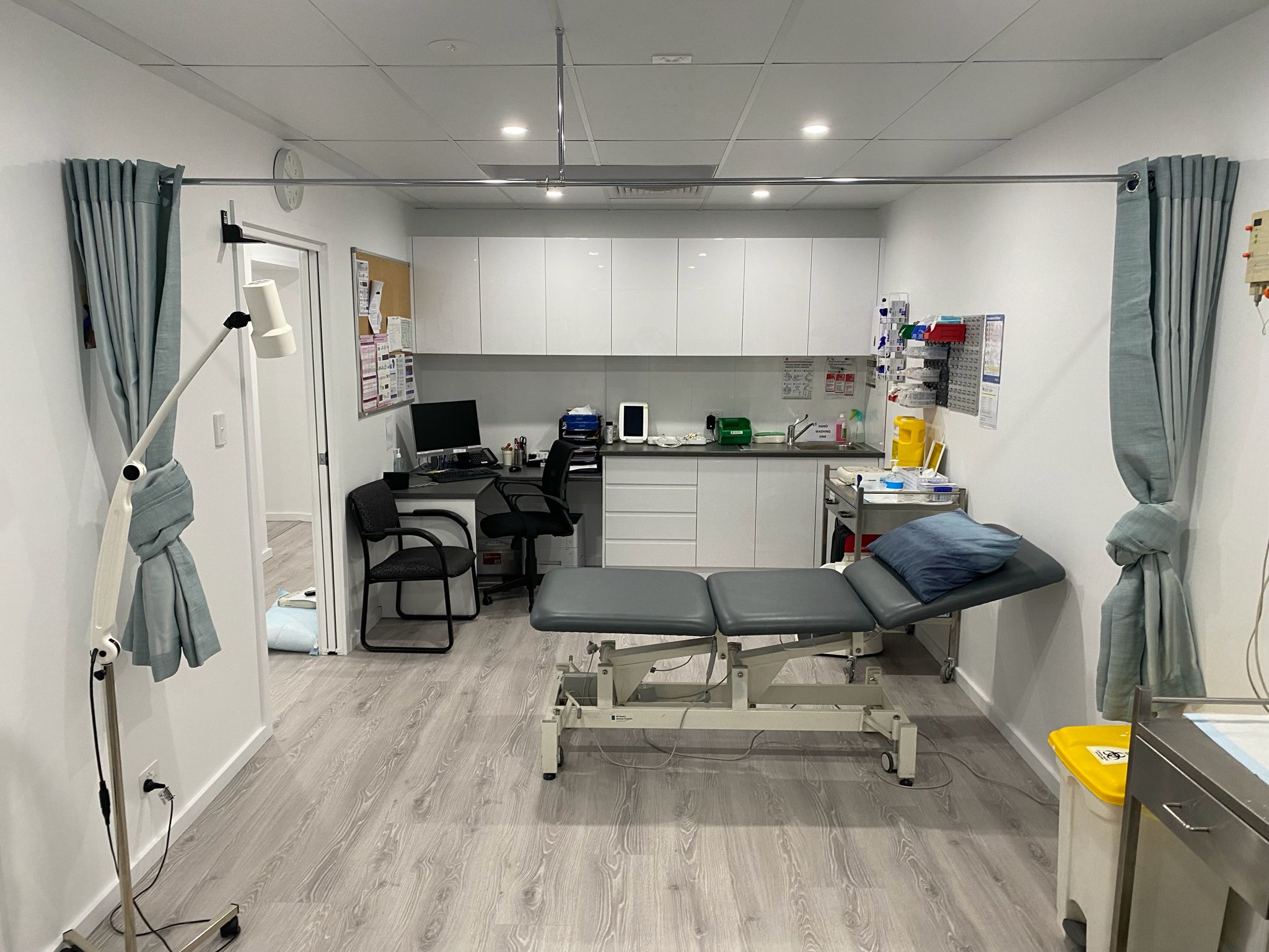 Treatment room with examination bed and clinical equipment